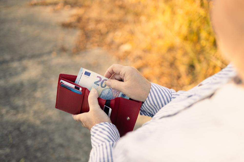 A woman takes cash out of her purse