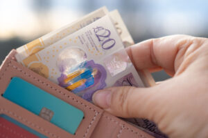 A person taking cash out of a purse